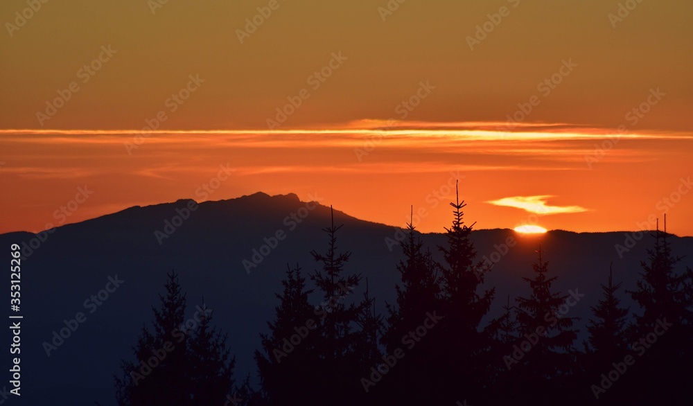 colorfully sunset over the mountains seen from high altitude