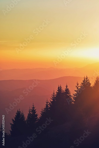 colorfully sunset over the mountains seen from high altitude © badescu