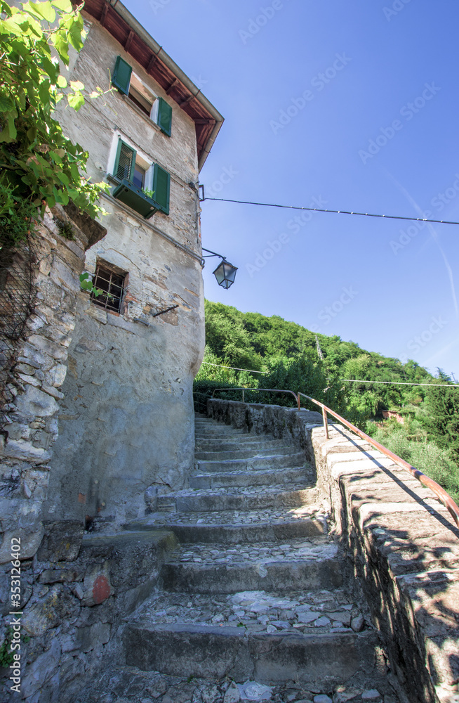 cobbled staircase of a picturesque village in Lombardy with panoramic mountain views