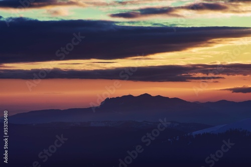 colorfully clouds at sunset in top of the mountain on winter time at high altitudes © badescu