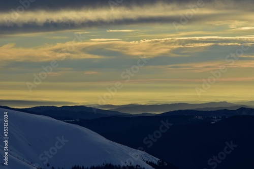 colorfully clouds at sunset in top of the mountain on winter time at high altitudes © badescu