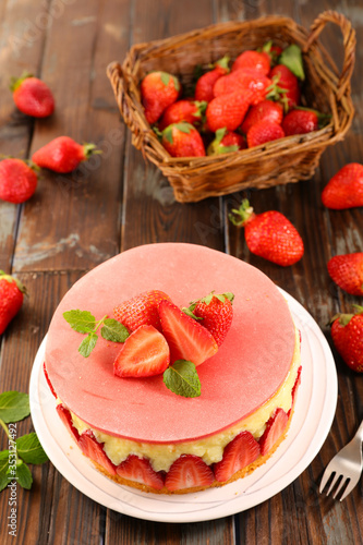 strawberry cake with cream on wood background