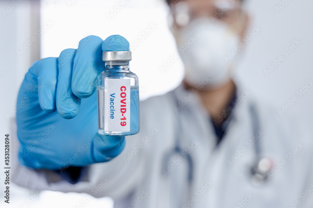 Healthcare cure concept. a doctor hold vaccine on hand in blue medical gloves. during Coronavirus crisis, Covid 19 virus. Healthcare cure concept. a doctor hold vaccine on hand in blue medical gloves. during Coronavirus crisis, Covid 19 virus.