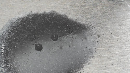 Acid etching metal in an industrial process