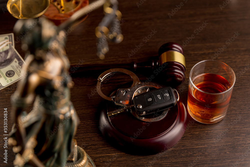 Car keys and glass of alcohol on table in pub or restaurant. Car keys and glass of alcohol on table in pub or restaurant.
