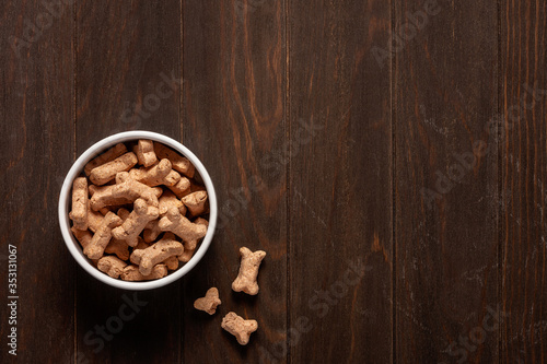 Dog food. Dry food on a wooden background. Copy space.