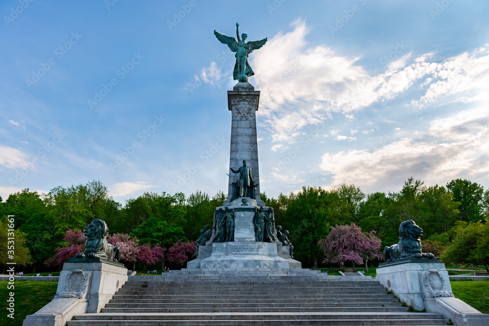 Monument to Sir George-Étienne Cartier in Mount Royal Park, front view with clouds and blue sky, 