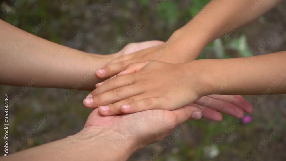 Happy mother touching soft skin of cute small hands of her son with love and tenderness. Happy mother touching soft skin of cute small hands of her son with love and tenderness.