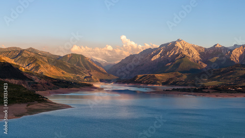 Fototapeta Naklejka Na Ścianę i Meble -  Beautiful mountain lake. Amazing mountain landscape with lake and sunset. Uzbekistan, Charvak Lake, 2020