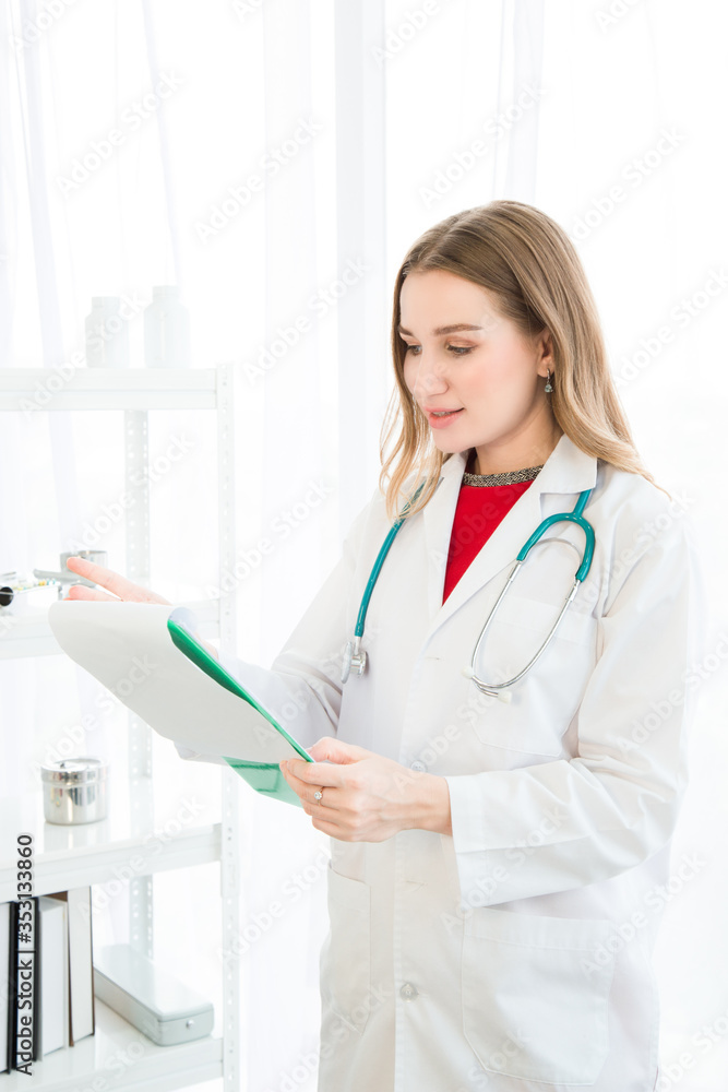 Female beautiful wearing a doctor uniform have a stethoscope and holding a green paper chart and smiling. Female beautiful wearing a doctor uniform have a stethoscope and holding a green paper chart and smiling.