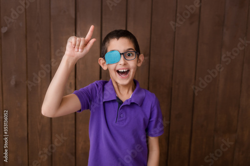 Portrait of boy in glasses with patch. Eye patch for glasses t treat lazy eye, amblyopia, strabismus. 