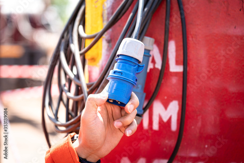 Картината върху платно Close-uo at safety officer's hand during inspection or examine the Electricity power plug which is use in field operation