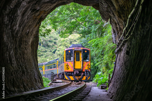 Train with Tunnel of Pingxi Line, Taiwan - Single-track railway branch line of the Taiwan Railway Administration, shot in Pingxi District, New Taipei, Taiwan. photo