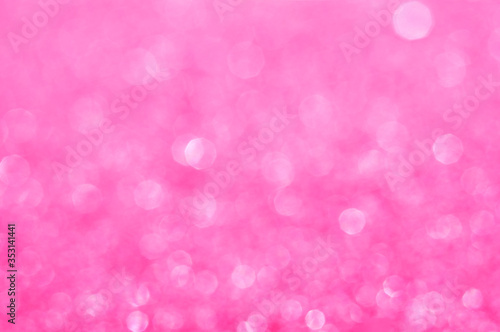 Pink defocused glitter background with copy space. Christmas background. Pink holiday glowing abstract background. Fuchsia blurred bokeh