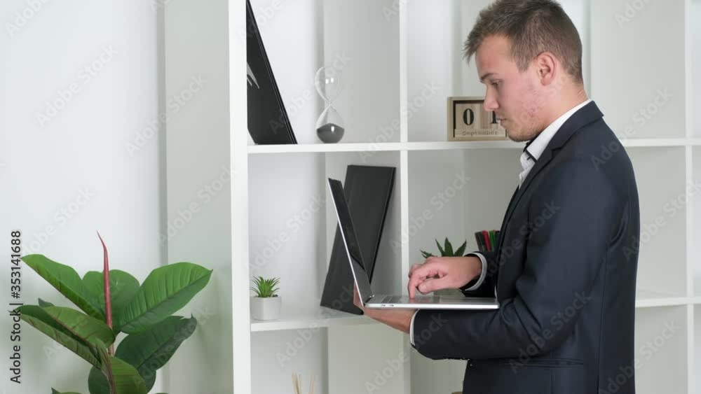 Business concept. Businessman working on laptop in company office Business concept. Businessman working on laptop in company office