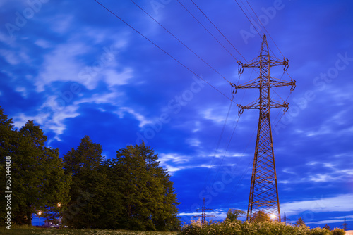Transmission tower, power tower or electricity pylon - long exposure night photo.