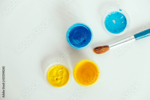 Wallpaper Mural Colorful gouache paints and brush for painting on white wooden table. Top view. Copy, empty space for text Torontodigital.ca