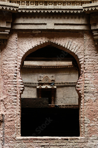Arches at from the stone work at old buildings in Gujarat, the typical red stones and architecture is signature of the Gujarat region in India