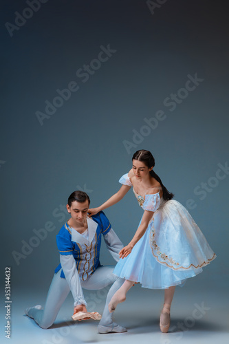 фотографія Young and graceful ballet dancers as Cindrella fairytail characters on studio background
