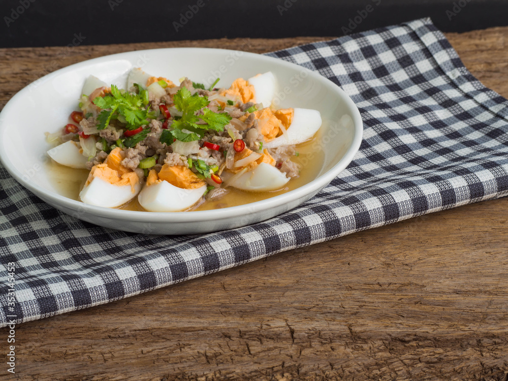 Close up boiled egg salad on wood background. Thai food concept. Close up boiled egg salad on wood background. Thai food concept.