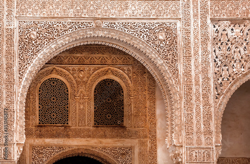 Beautiful decoration on arches inside medieval architecture complex, the 4th century palace Alhambra