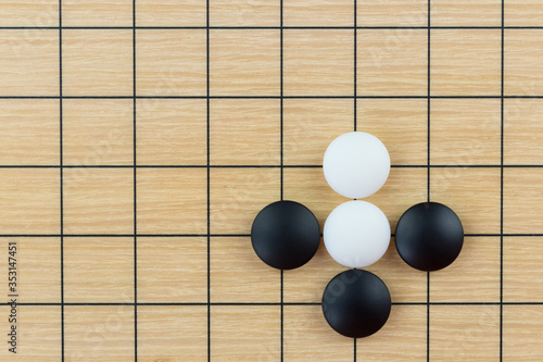 Simple training position of black and white stones on the playing field (gohan) of Chinese game go