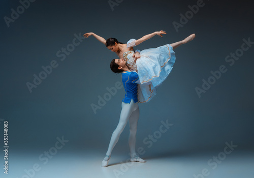 Φωτογραφία Young and graceful ballet dancers as Cindrella fairytail characters on studio background