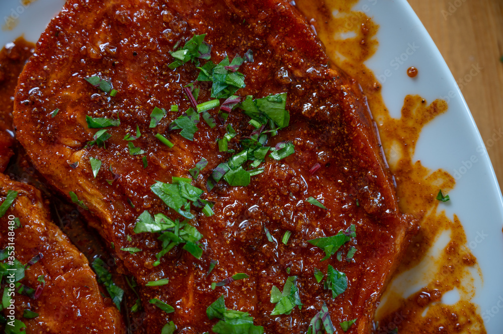fresh neck steak of pork marinated with paprika and oil with fresh herbs on top ready to grill fresh neck steak of pork marinated with paprika and oil with fresh herbs on top ready to grill