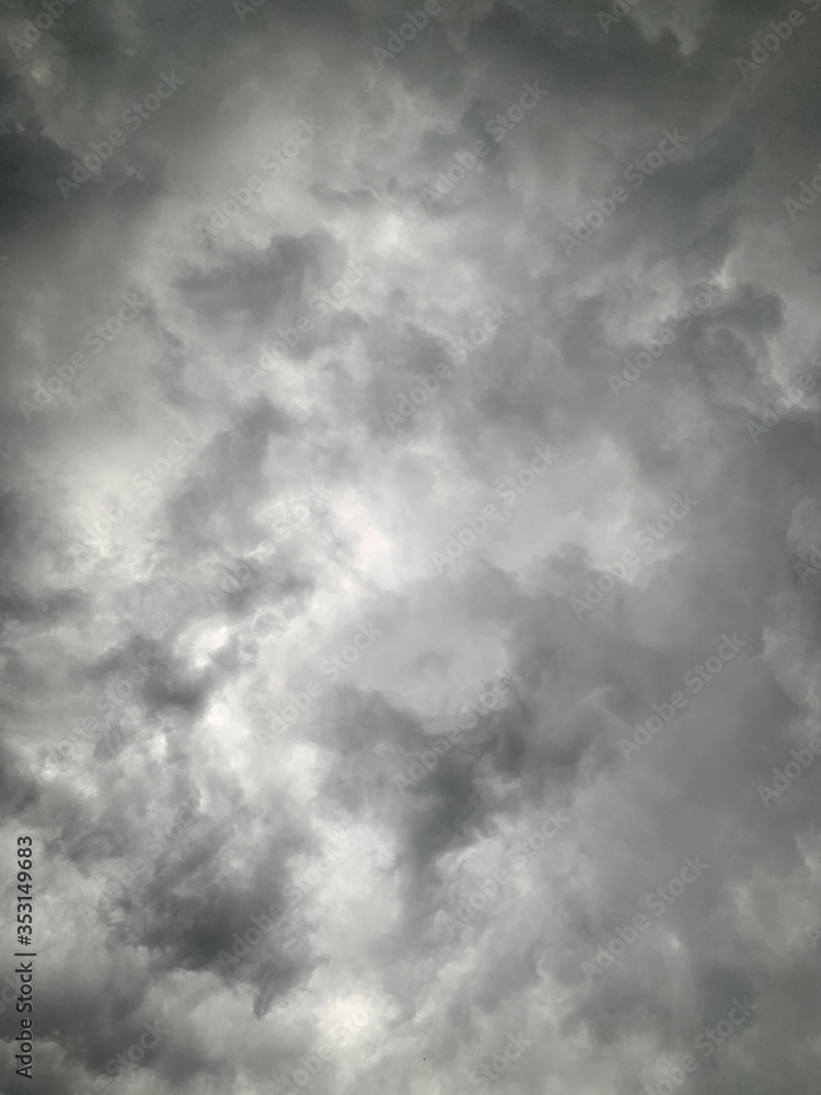 Obraz premium Black clouds formed before the rain, used for make a background image. Rain clouds background.Clouds become dark gray like a big smoke before rainfall. Thunderstorm is a storm with lightning and thund