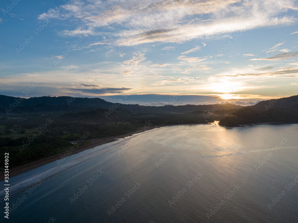 Fototapeta premium Sunset over the ocean with clouds in the background