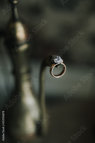 wedding ring hanging on the spout of the kettle