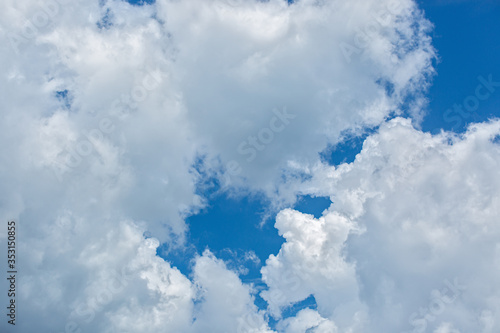 White cumulus clouds on blue sky background