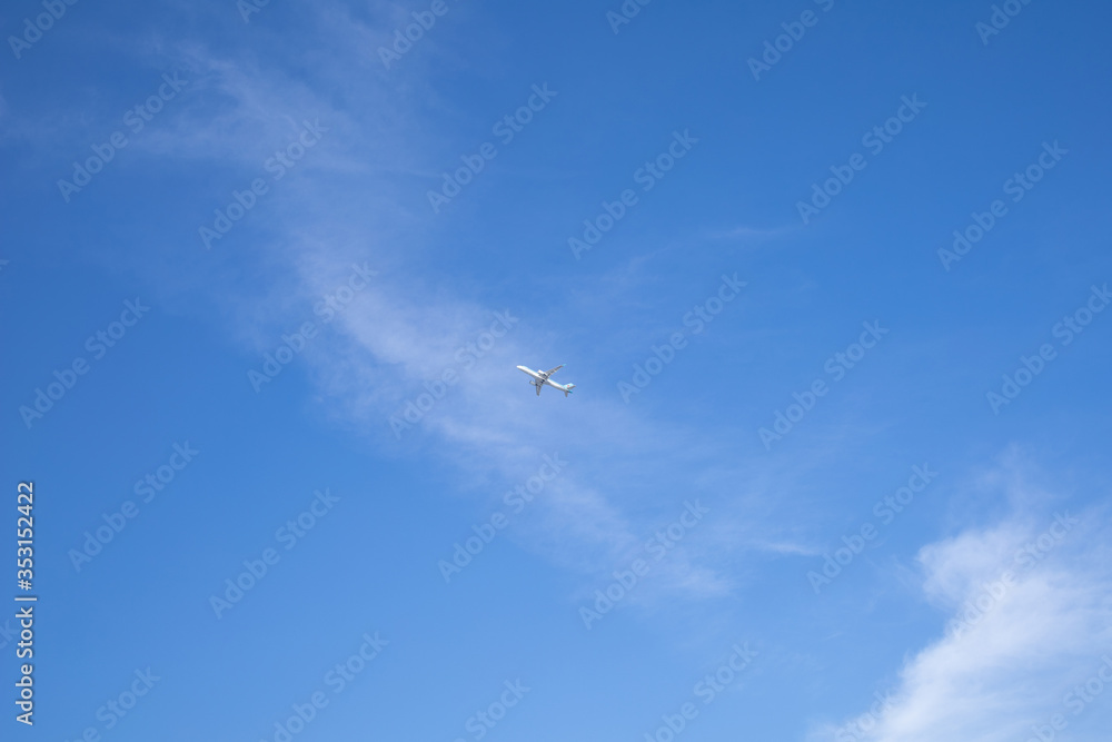 a small plane seen far into the blue sky. a small plane seen far into the blue sky.