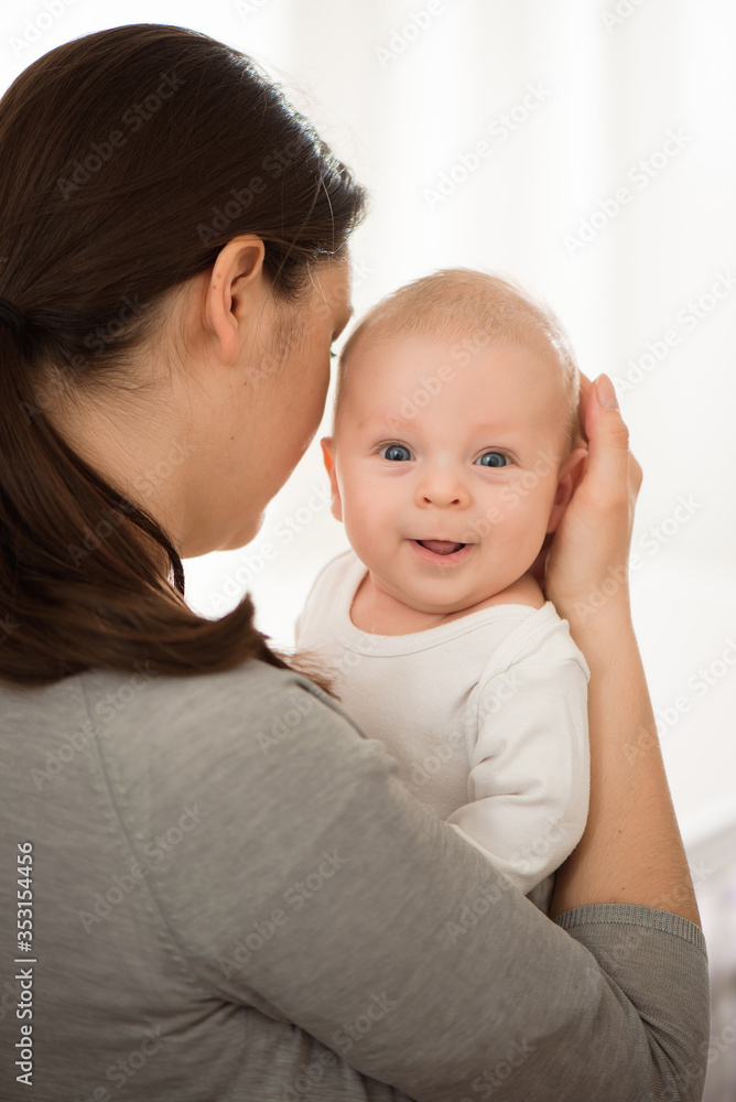 Portrait of happy mother and baby, parent and little kid relaxing at home. Family having fun together. Portrait of happy mother and baby, parent and little kid relaxing at home. Family having fun together.