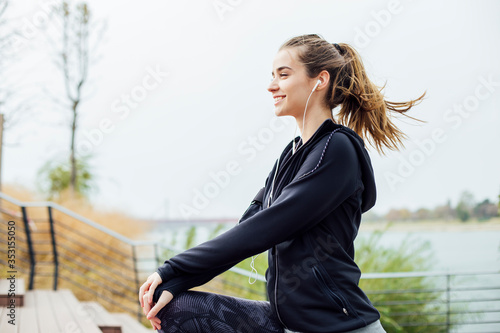 Fit young woman with earpho...