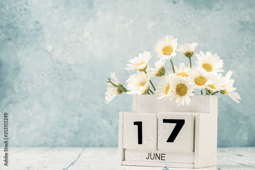 White cube calendar for june decorated with daisy flowers