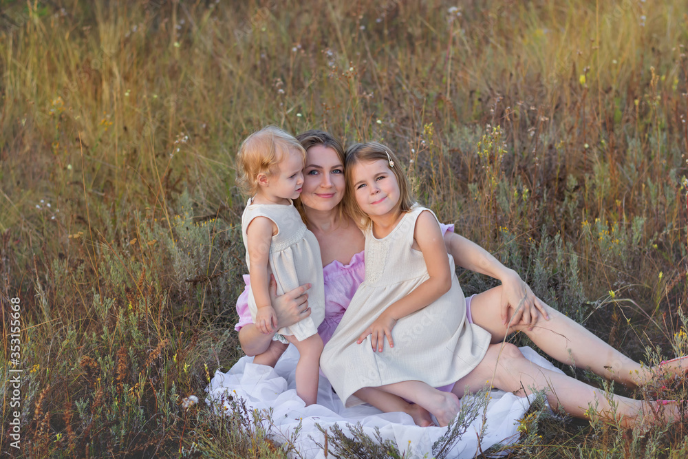 Fototapeta premium happy mother and two daughters in nature