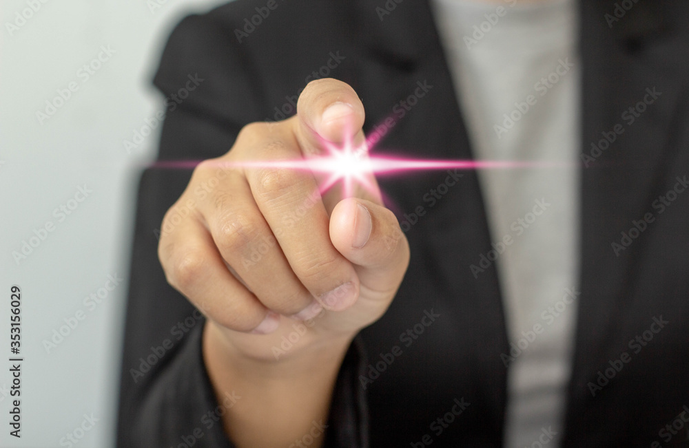 A businesswoman pointing a finger to give orders or force to follow,soft focus background A businesswoman pointing a finger to give orders or force to follow,soft focus background
