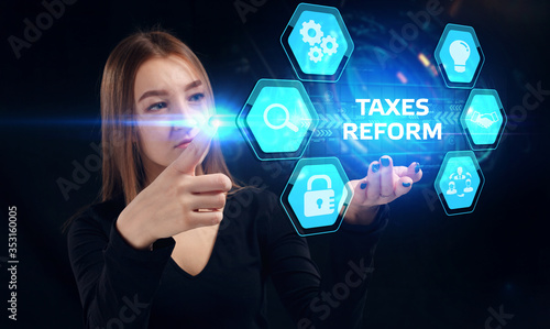 Business, Technology, Internet and network concept. Young businessman working on a virtual screen of the future and sees the inscription: Taxes reform