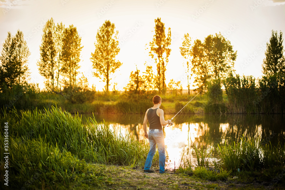 man catches fish on the river. beautiful sunset. hobby fishing
man catches fish on the river. beautiful sunset. hobby fishing