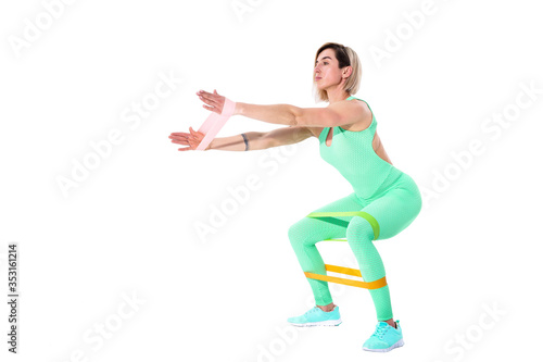 Woman exercising fitness resistance bands in studio silhouette isolated on white background.