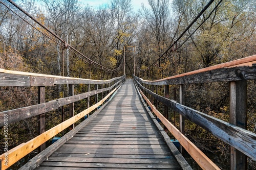 Suspension bridge in the autumn forest