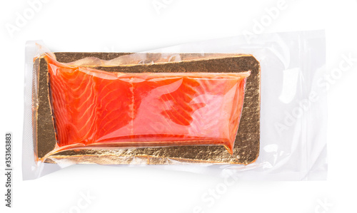 Photos A piece of salmon fillets in a vacuum blister pack isolated on white background,