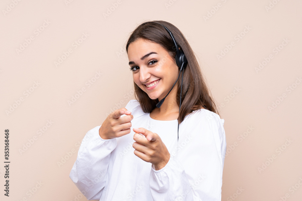 Young telemarketer woman over isolated background points finger at you with a confident expression Young telemarketer woman over isolated background points finger at you with a confident expression