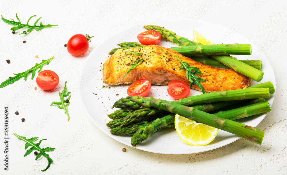 Baked salmon garnished with asparagus and tomatoes with herbs Baked salmon garnished with asparagus and tomatoes with herbs