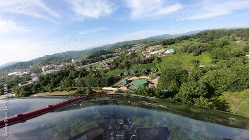 Wallpaper Mural A small red helicopter flies over the city. The footage was taken from the fuselage of a helicopter Torontodigital.ca