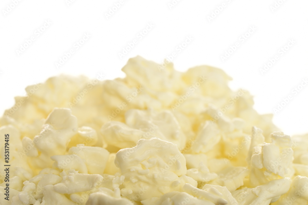Fresh tasty, nutritious cottage cheese, close-up, on a white background.