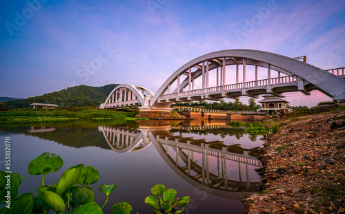 White Bridge or Saphan Tha Chomphu with reflection in twilight at Lamphun, Thailand. © somchairakin