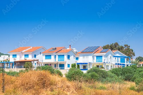 Cyprus. Pissouri village. Apartments in village of Pissouri. Solar panels are installed on the roof of the houses. Renewable energy. Traveling to Cyprus. Pissouri holiday resort. Cyprus architecture photo