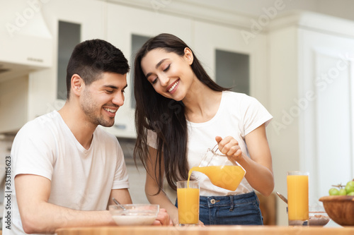 Young caucasian man and woman enjoying lemonade